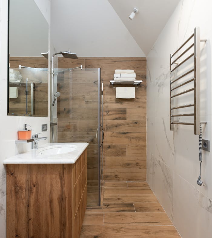 modern-bathroom-with-white-clean-sink-and-timber-walls-6587851 Luxurious contemporary bathroom interior with wooden and marble design elements.